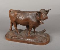 A 19th century carved Black Forest cow Naturalistically worked, standing on an integral plinth base.