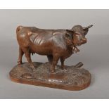 A 19th century carved Black Forest cow Naturalistically worked, standing on an integral plinth base.