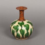 A Chinese Tang style porcelain vase The body with green drip glaze, the neck ochre. 19.5 cm high.