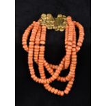 A four strand coral bead necklace Set with an unmarked gold filigree clasp. 29 cm long.