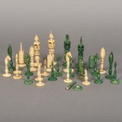 A 19th century ivory and green stained ivory chess set The King's each 10 cm high.