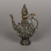 A Chinese cast metal ewer The body relief moulded with figures. 18.5 cm high.