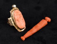 A 10K gold coral and seed pearl mounted ring Carved with a head of a young lady;
