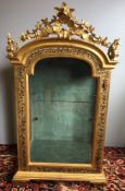 A 19th century Continental painted and carved giltwood glazed display cabinet The boned top with