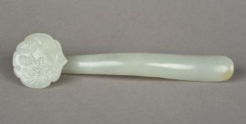 A Chinese carved celadon jade ruyi sceptre Of typical form. 14.5 cm long.