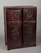 A 19th/20th century Chinese carved hardwood table cabinet The two pairs of panelled doors worked