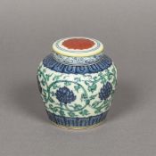 A Chinese porcelain ginger jar and cover Decorated with lotus strapwork, blue painted mark to base.