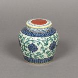 A Chinese porcelain ginger jar and cover Decorated with lotus strapwork, blue painted mark to base.