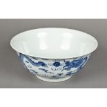 A late 19th century Chinese blue and white porcelain bowl Finely painted with dragons chasing