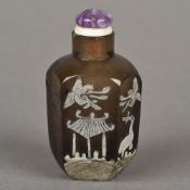 A Chinese overlaid smoky quartz snuff bottle Of faceted form, decorated with birds and bats. 6.