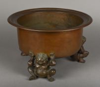 An Eastern bronze censor The deep bowl supported on three mythical figures. 45.5 cm diameter.