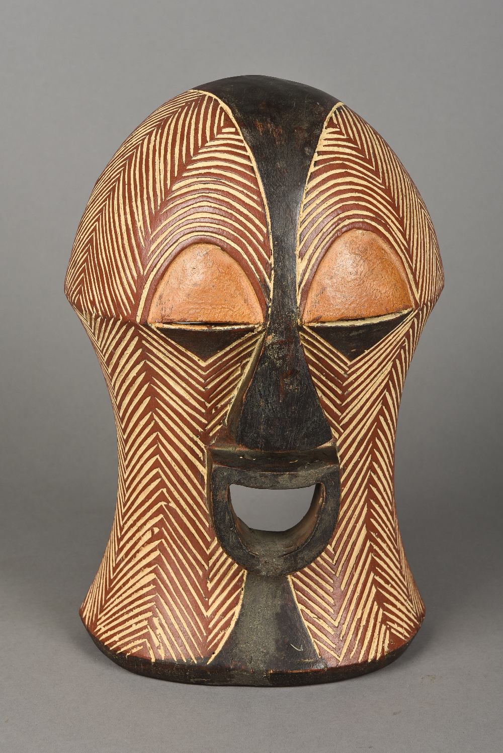 A Luba carved and polychrome decorated Kifwebe mask With stylised features. 33.5 cm high.