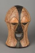 A Luba carved and polychrome decorated Kifwebe mask With stylised features. 33.5 cm high.