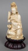 A Chinese carved ivory figure of Guanyin Typically modelled seated holding a bead necklace and