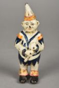 A cast iron clown money bank With painted decorations. 13.5 cm high.