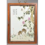 A Chinese famille rose porcelain plaque Painted with a crane in a tree above two deer and with
