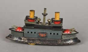 An early 20th century clockwork tinplate model of an iron clad steam battle ship With twin funnels