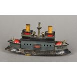 An early 20th century clockwork tinplate model of an iron clad steam battle ship With twin funnels