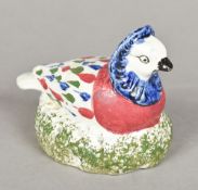 An early 19th century pearlware model of a bird Modelled nesting. 12 cm long.