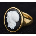 An 18 ct gold agate cameo set ring, hallmarked for 1912, the cameo earlier 2 cm high.