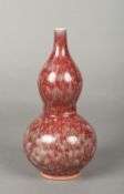A Chinese porcelain double gourd vase With allover red/green mottled glaze. 20.5 cm high.