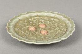 A Chinese Ming Dynasty porcelain celadon glazed dish Worked with scrolling vines and unglazed