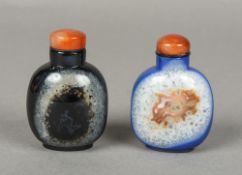 Two Chinese carved mineral snuff bottles and stoppers Both 7.5 cm high.
