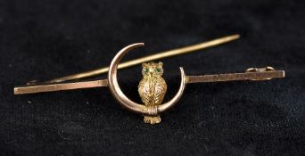 An Edwardian 9 ct gold bar brooch Centred with an owl in a crescent moon,