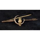 An Edwardian 9 ct gold bar brooch Centred with an owl in a crescent moon,