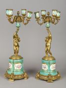 A pair of Sevres type gilt bronze mounted porcelain candelabra Each with four scrolling branches