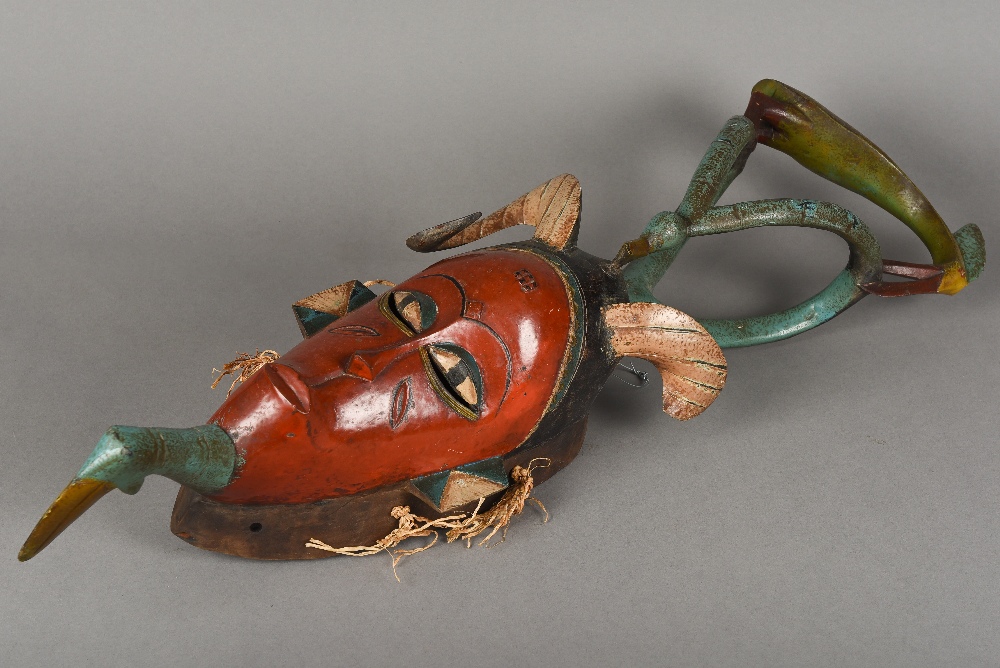 A Guro carved and polychrome decorated mask The slender scarified face surmounted by horns and