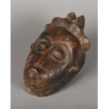 A Guro carved wood mask The face with scarification marks. 27 cm high.