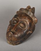 A Guro carved wood mask The face with scarification marks. 27 cm high.