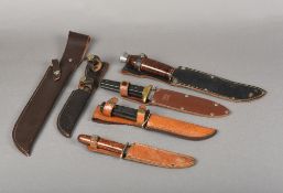 Four various bowie knives All with leather sheaths; together with two vacant leather sheaths.