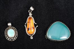 Two white metal pendants One set with turquoise and stamped 925,