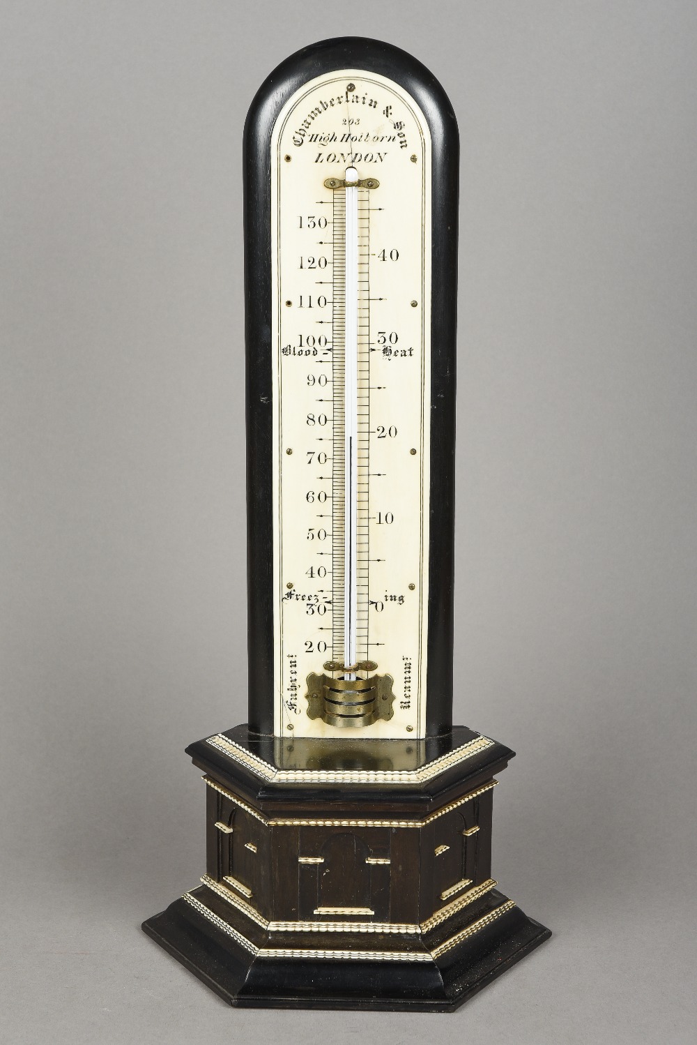 A 19th century ivory and ebony table thermometer With ivory mounted stepped plinth base,