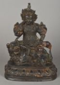 A Chinese painted bronze model of a figure, possibly a deity or an emperor Seated atop a temple dog.