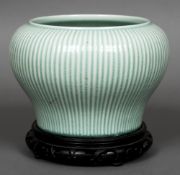 A Chinese porcelain baluster vase on stand Of ribbed form with allover celadon glazed.