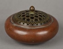 A small Chinese patinated bronze censor With pierced removable lid,