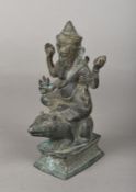An antique Indian cast bronze figure of Ganesh Modelled seated on a rat,