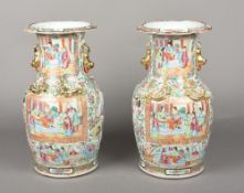 A pair of Chinese Canton porcelain vases Typically decorated with figural vignettes. 35 cm high.
