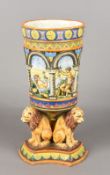 A Continental majolica vase The arcaded bowl decorated with bathers in a continuous landscape,