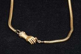 A 9 ct gold snake link chain set with a diamond inset hand form clasp 62.5 cm long.