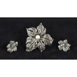 An unmarked pearl centred pierced floral brooch Set with rose cut stones;