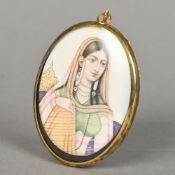 An Indian miniature portrait on ivory Depicting a bejewelled young lady, framed and glazed. 6.