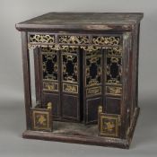 A Chinese carved wood and gilt decorated shrine cabinet Worked as a pagoda. 53 cm high.