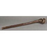 An unusual tribal carved hardwood club The slender handle with drilled suspension loop holes,