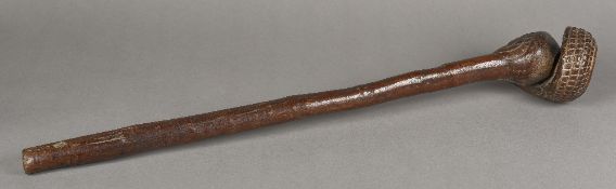 An unusual tribal carved hardwood club The slender handle with drilled suspension loop holes,