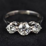 An 18 ct white gold three stone diamond ring The shank marked for 1.245 carats.