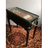 A vintage Tilter pinball table With ebonised case, the board of typical form,